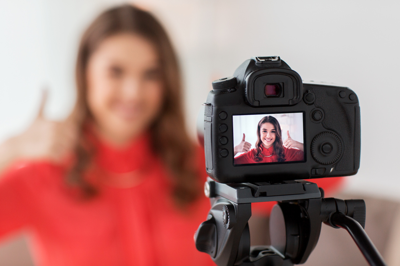 Woman with Camera Recording Video 